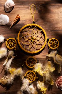 Handcrafted Dreamcatcher – Yellow Thread & Feather Design